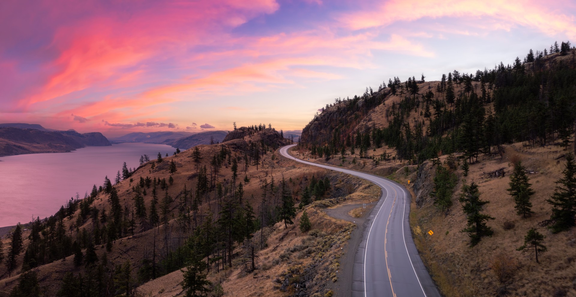 Aerial view of a highway in valley during sunrise in Kamloops, BC, Canada