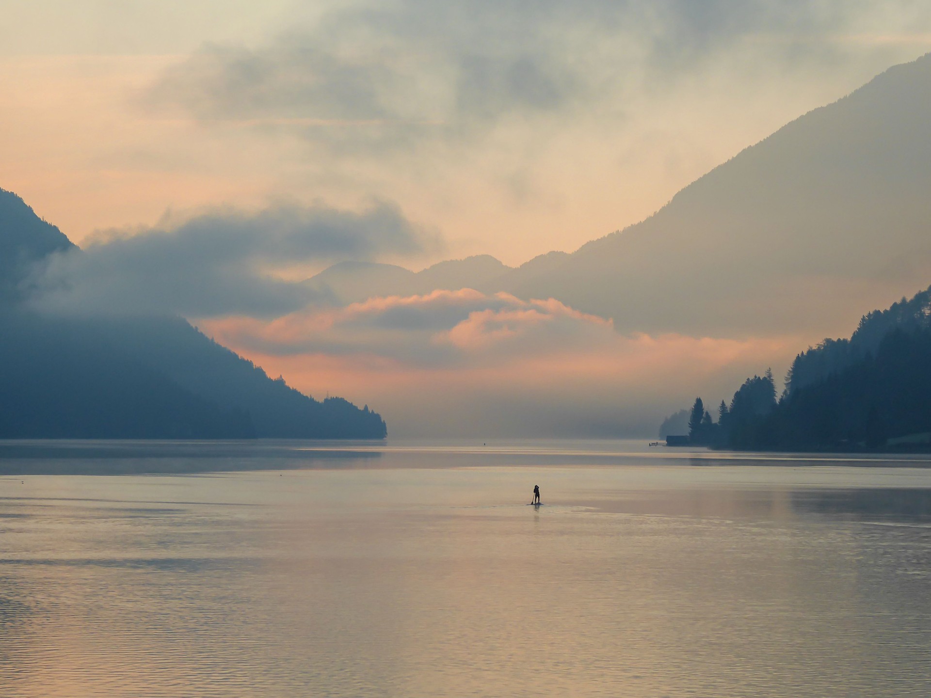 Weissensee - A stand up paddling man towards the sunset